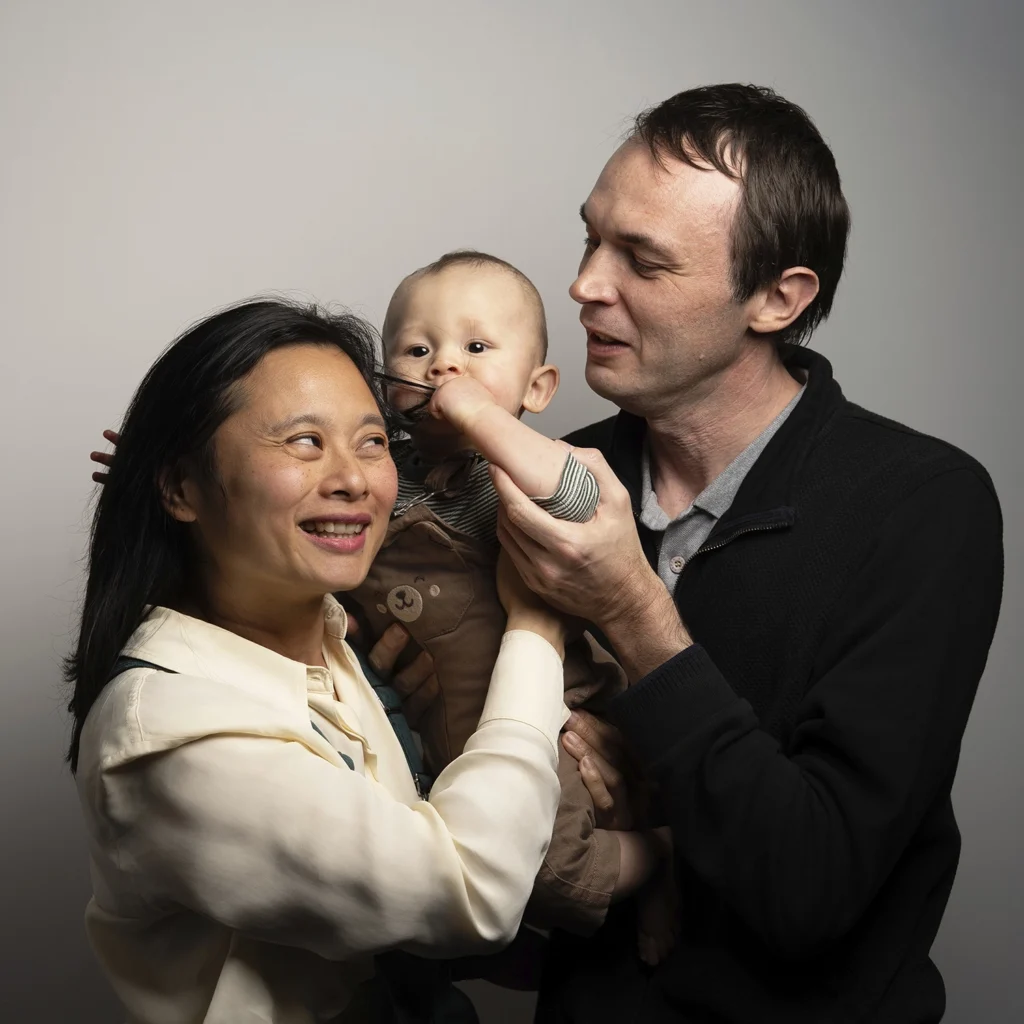Les deux parents partagent un moment de tendresse avec leur bébé.